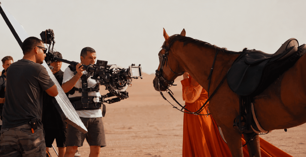 Film crew shooting a cinematic horse scene in the Dubai desert