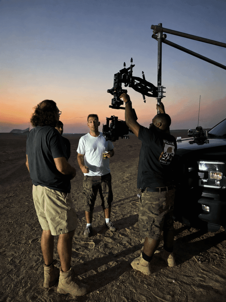 Toosuns film crew setting up a camera rig at twilight behind the scenes