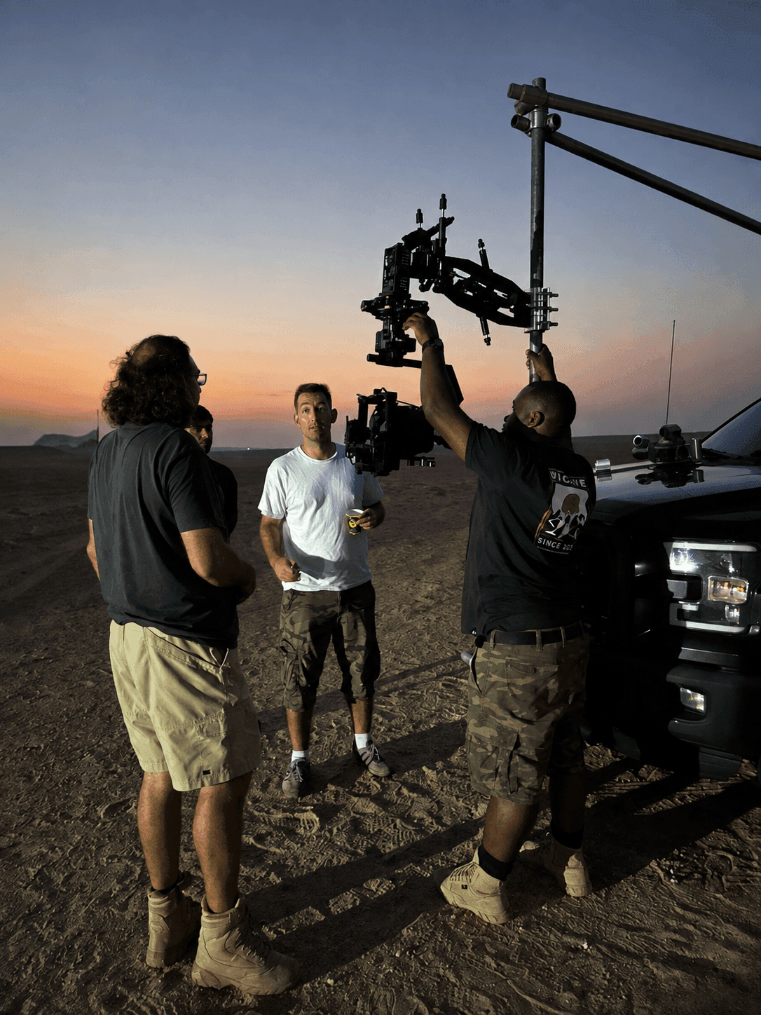Toosuns film crew setting up a camera rig at twilight behind the scenes