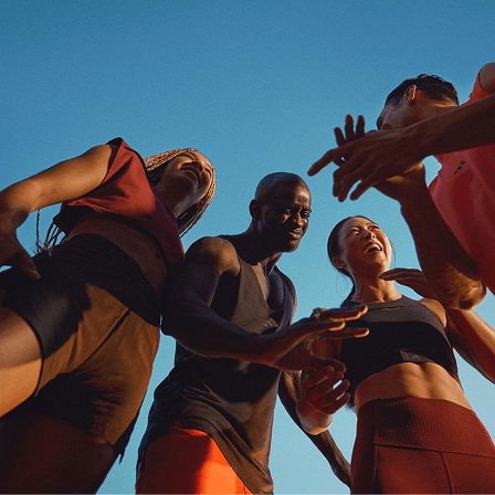 Portrait of Omar Al Mansoori with a group of athletes under a clear blue sky.