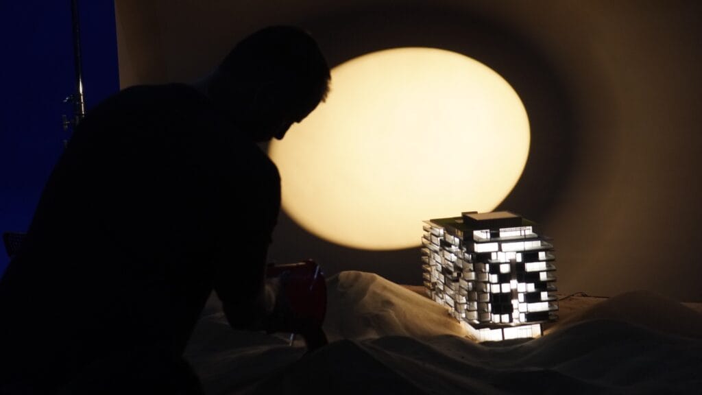 Behind the scenes of the Six Senses residence miniature set with dramatic circular backlighting.