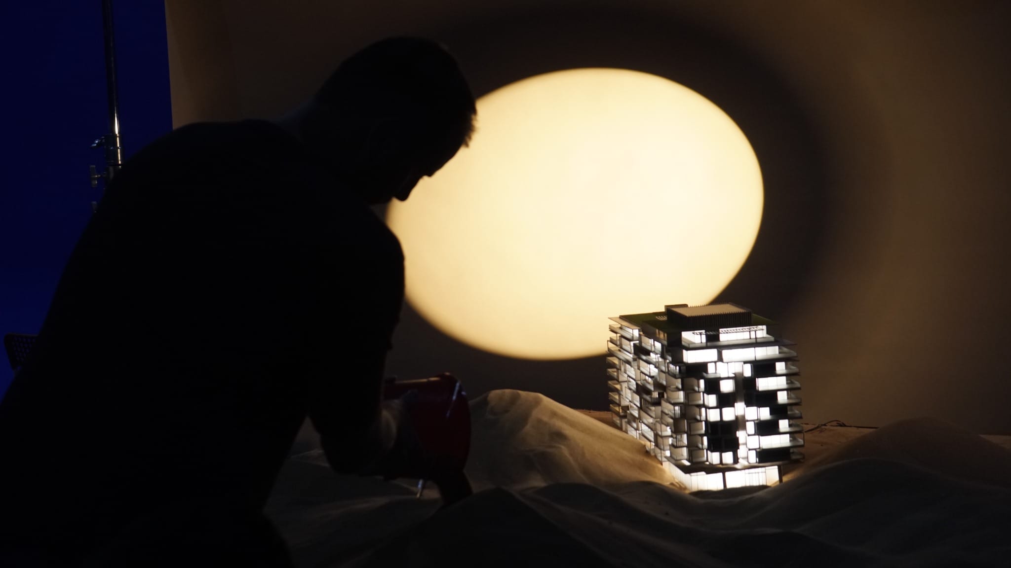 Behind the scenes of the Six Senses residence miniature set with dramatic circular backlighting.