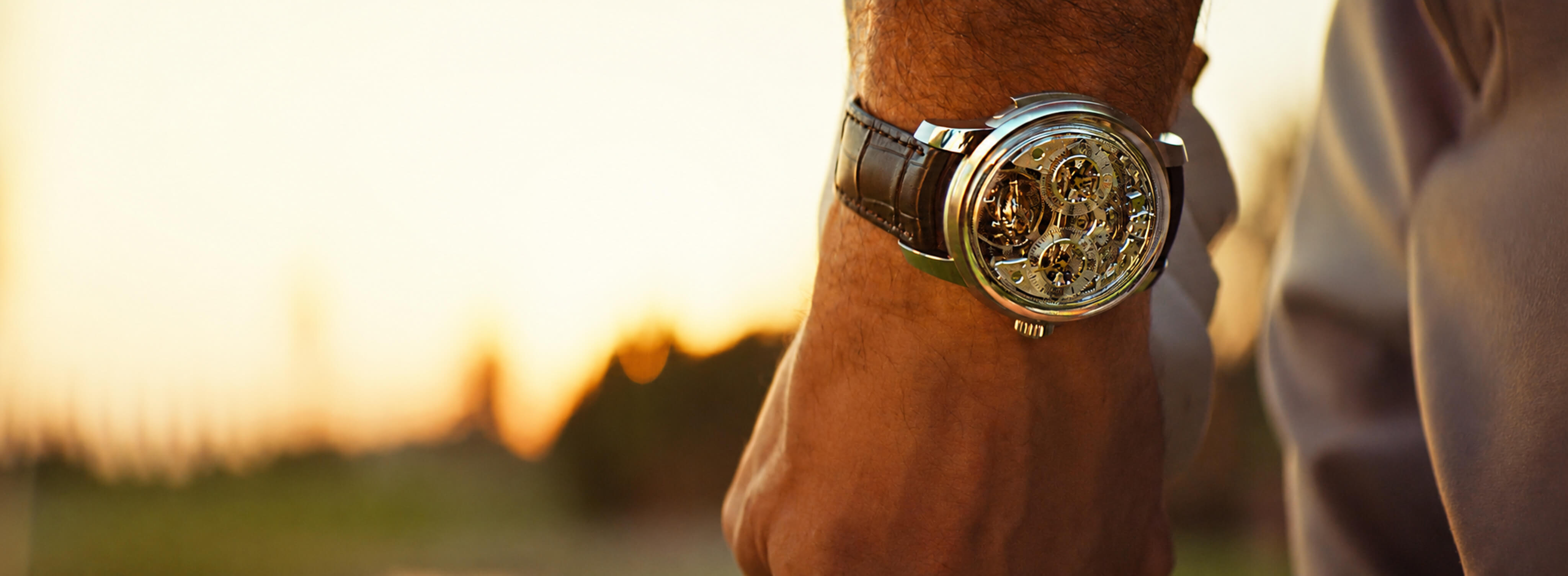 Skeleton luxury watch photographed on a man’s wrist at sunset for the Six Senses campaign.