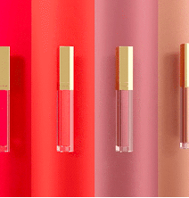 Colorful lip gloss tubes in red, pink, and nude shades.