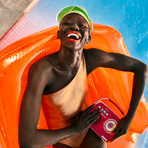 Woman relaxing on an orange inflatable pool float