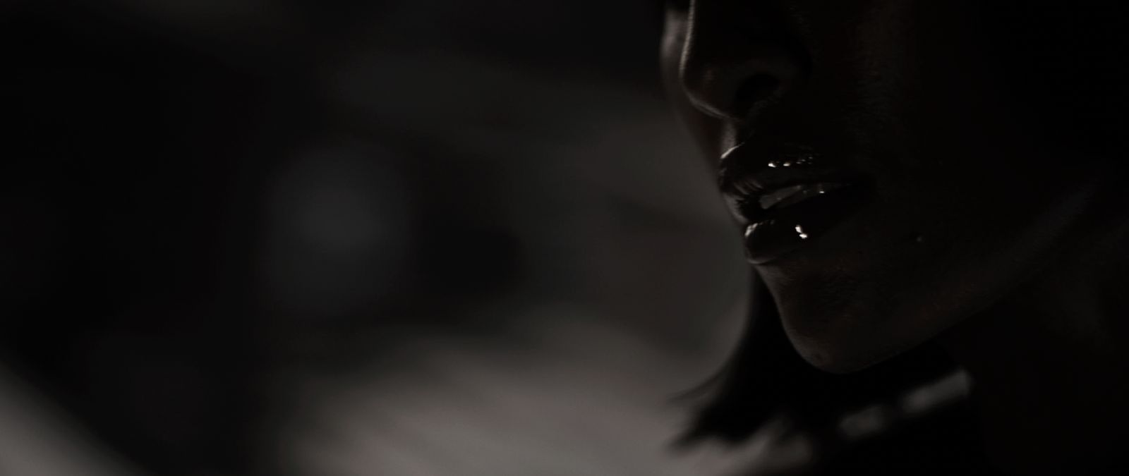 Close-up of glossy lips and sculptural shadows from the Ayan Beauty launch campaign