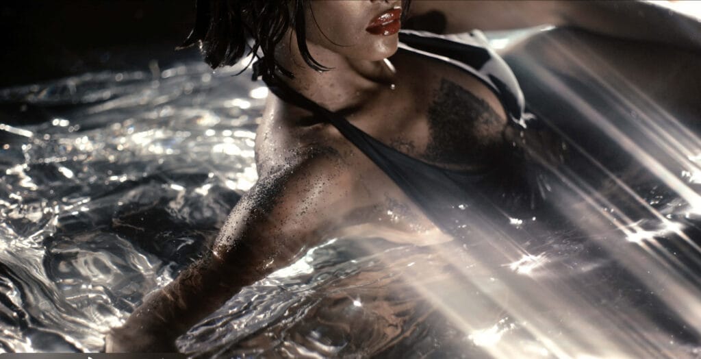 Ayan Beauty campaign model photographed in water with sculptural light and reflective textures